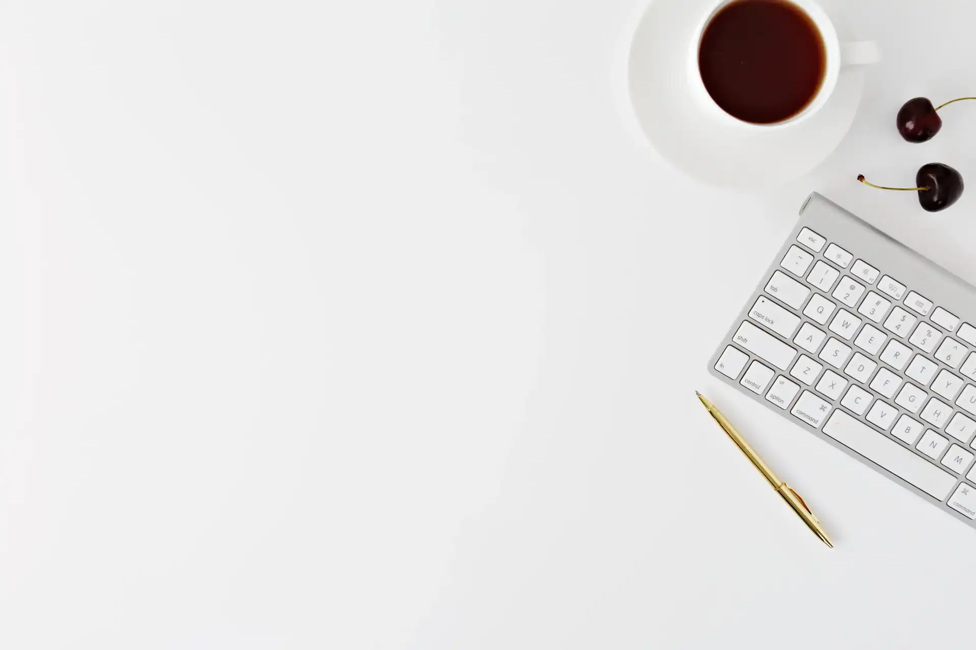 Empty table with just keyboard and coffee and few items