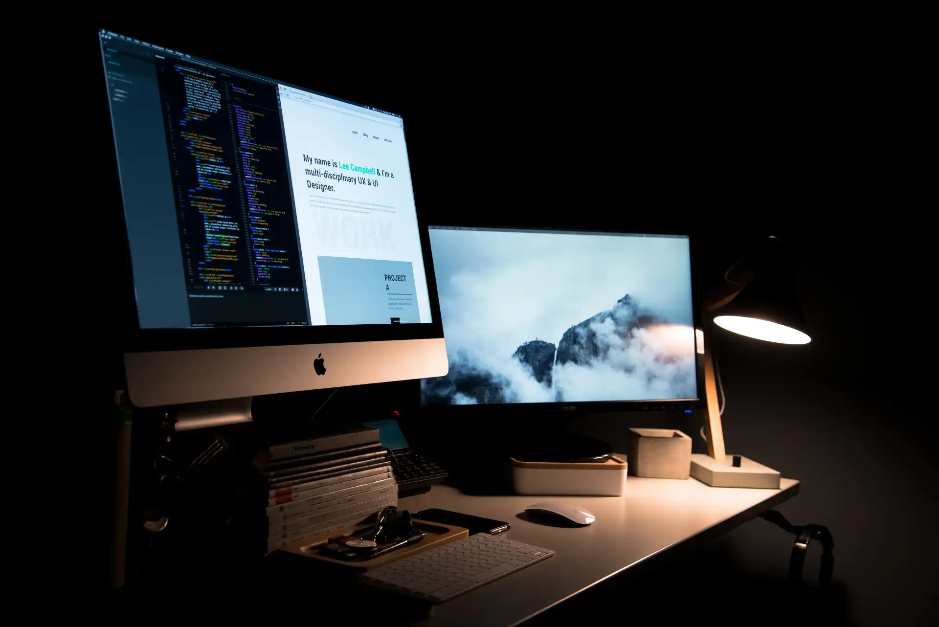 Late night coding with two monitors and small table light